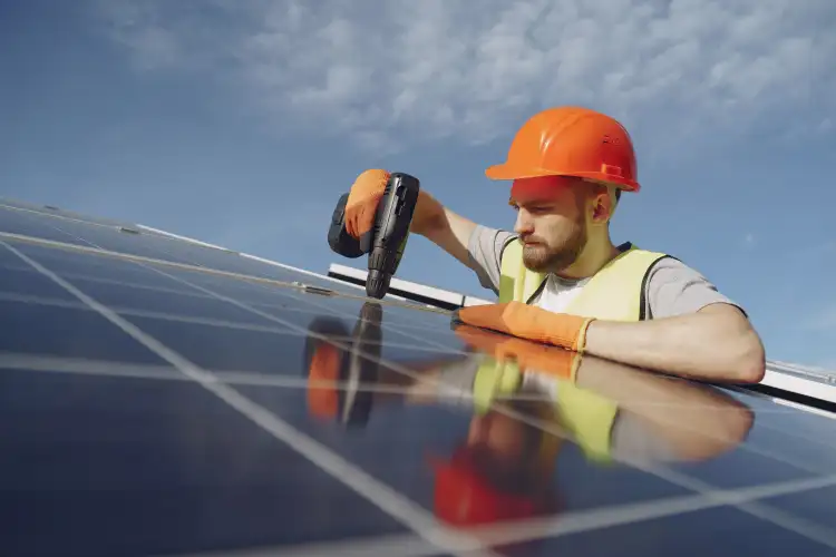 Solar installation technician mounting panels