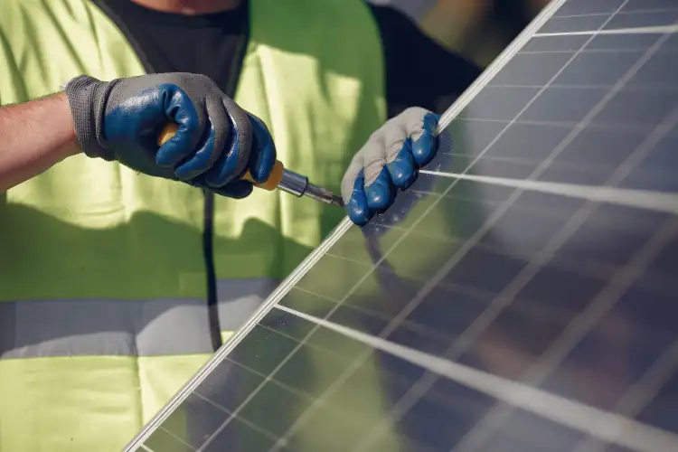 Solar installation technician mounting panels